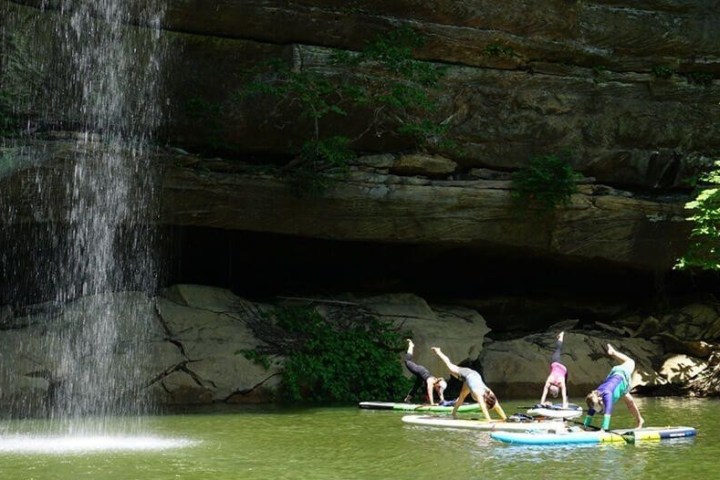 a person standing next to a body of water