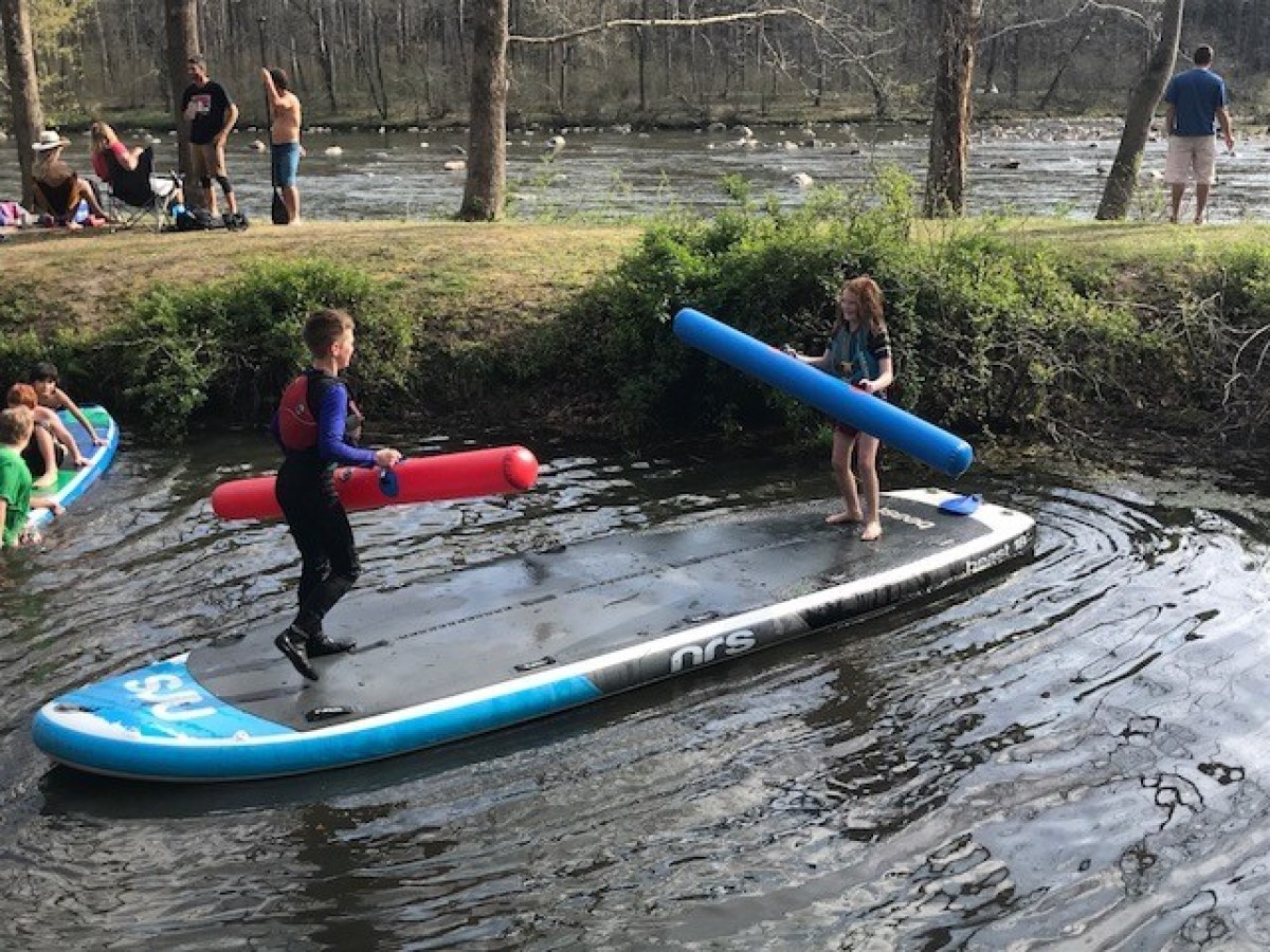 a group of people in a pool of water