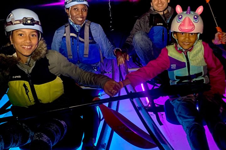A family in side-by-side tandem Crystal Clear Kayaks pose together on their tour of the Underground